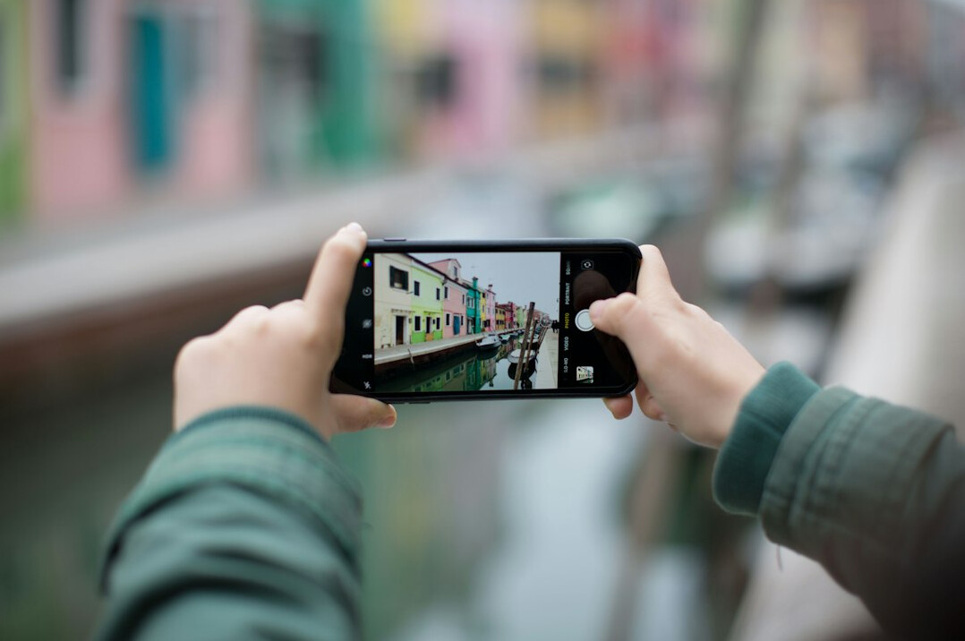 Smartphone screen with composition grid over a landscape photo